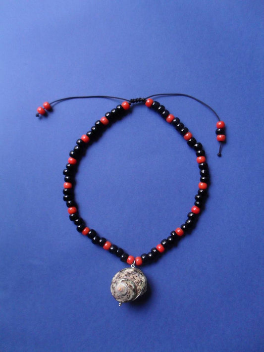 Necklace made of coral, beads and a shell