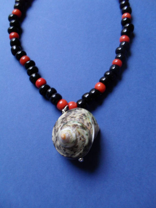 Necklace made of coral, beads and a shell